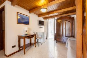 a bedroom with a desk and a table in a room at Case Vacanze Albamarina in Lipari