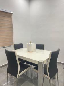 a table with chairs and a box on top of it at Singgah Salam Stay in Parit Raja