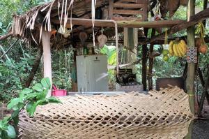 a man standing in a kitchen in a wicker at Camping AlterArte Ecovila in Santarém +1 photo