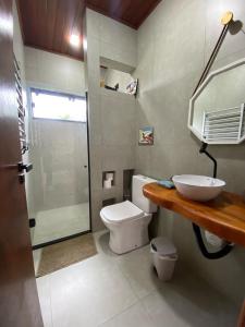 a bathroom with a toilet and a sink and a shower at Estação Serra Negra in Bezerros +11 photos
