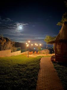 a brick path leading to a park at night at Estação Serra Negra in Bezerros