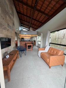 a living room with a couch and a table at Estação Serra Negra in Bezerros