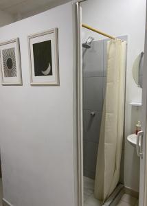 a bathroom with a shower curtain and a sink at La Casa Hostal Vijes in Vijes +41 photos