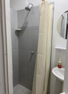 a shower with a shower curtain in a bathroom at La Casa Hostal Vijes in Vijes