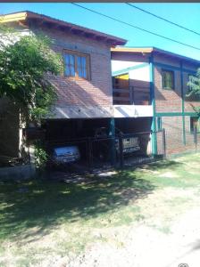 a house with a fence in front of it at Departamento Cura Brochero in Villa Cura Brochero