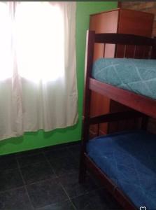 a bedroom with a bunk bed and a window at Departamento Cura Brochero in Villa Cura Brochero