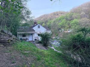 a white house on the side of a hill at Completely renovated for you Mountain View Cottage in Charleston