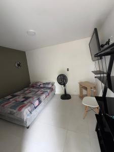 a bedroom with a bed and a desk and a fan at Habitaciónes Entradas Privadas independientes tipo APTO in Valledupar