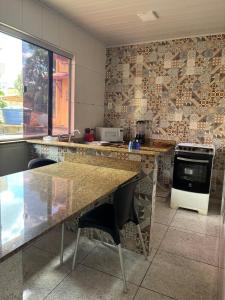 a kitchen with a table and chairs in a room at Apartamento - Vila Isa in Governador Valadares +7 photos