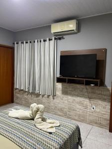 a bedroom with a bed with a towel on it at Apartamento - Vila Isa in Governador Valadares