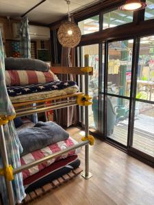 a room with a bunch of pillows on display at Norishicoauto Guesthouse in Chikushino