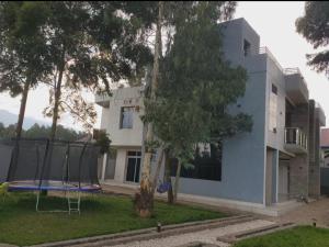 a house with a playground in front of a building at Ni HOME & RELAX in Ruhengeri