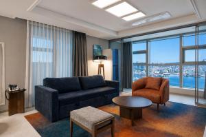 a living room with a couch and a chair at Matie Busan Harbor City in Busan