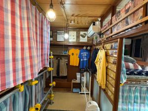 a shop with a room with shirts on shelves at Norishicoauto Guesthouse in Chikushino +40 photos