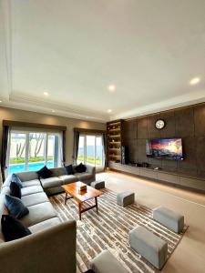 a large living room with a couch and a table at Al Andalus Resort Puncak in Puncak