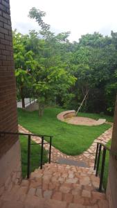 a stone path leading to a park with trees at Nossa Casa em Lençóis - Bahia in Lençóis