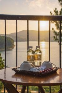 a table with two bottles of water on a plate at Romeo & Juliet's Hồ Tuyền Lâm Dalat in Da Lat