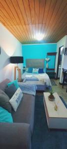 a living room with two beds and a couch at Studio Monoambiente Urbano en radar centrico,completo y funcional con Alexa in Ushuaia