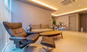 a living room with a couch and a table at Aldea de Pangsion Pool Villa in Pohang