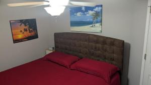 a bedroom with a bed with a red blanket at Whale Hill Escape - Beach Views and Walk to Mannys in Puerto Peñasco