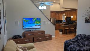 a living room with a flat screen tv on a dresser at Whale Hill Escape - Beach Views and Walk to Mannys in Puerto Peñasco