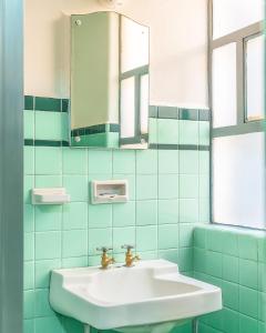 a bathroom with a sink and a mirror at Hotel Mariscal in Mexico City