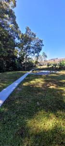 a walking path in a park with trees and grass at Chalé in Alfredo Wagner +5 photos