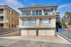 a large house with a garage in front of it at Blue Pacific Apartment 8 in The Entrance