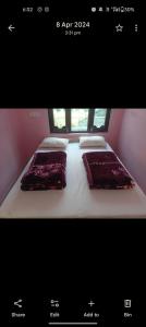 a picture of a bed with two pillows on it at Hotel suryoday kharadi in Kutnaur +15 photos