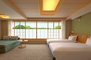 a hotel room with two beds and a couch at Nemu Resort Hotel Nemu in Shima +80 photos
