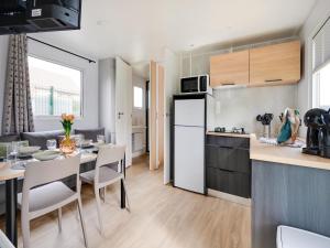 a kitchen and dining room with a dining table and a kitchen and a kitchen at Berlare Retreat for 6 with garden in Berlare