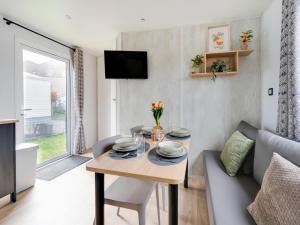 a living room with a table and a couch at Berlare Retreat for 6 with garden in Berlare
