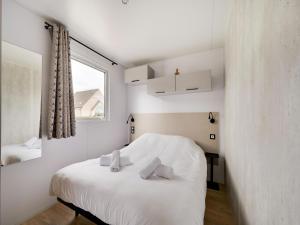 a bedroom with a bed with white sheets and a window at Berlare Retreat for 6 with garden in Berlare