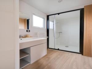 a bathroom with a white sink and a shower at Berlare Retreat for 6 with garden in Berlare +33 photos