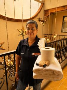 a woman is holding a roll of toilet paper at El Suburbio - Serapio Rendon in Morelia