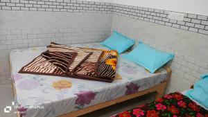 a couple of beds with pillows on them at Hotel suryoday kharadi in Kutnaur