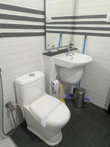 a bathroom with a toilet and a sink at HILL TOP HOMES in Kannur +25 photos