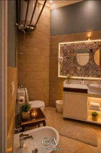 a bathroom with a sink and a toilet and a tub at GAP Cairo Hotel Downtown in Cairo +13 photos
