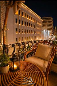 a wooden bench on a balcony with a building at GAP Cairo Hotel Downtown in Cairo