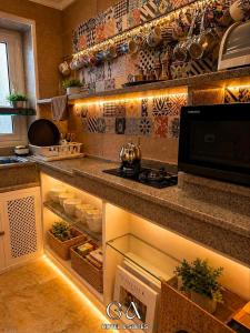 a kitchen with an open pantry with pots and pans at GAP Cairo Hotel Downtown in Cairo