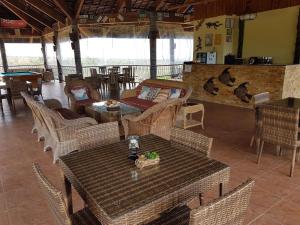 a restaurant with tables and chairs in a room at The Halfway Cafe-Dauin, Glamp1 - Cricket in Dauin