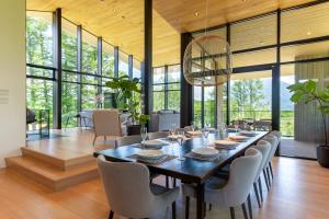 a dining room with a long table and chairs at Kazahana at Hanaridge in Kutchan
