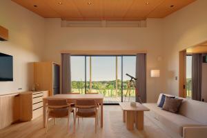 a living room with a couch and a table at Nemu Resort Hotel Nemu in Shima