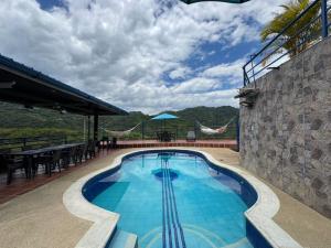 a swimming pool on the side of a building at Finca Altamira in La Vega