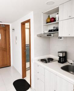 a kitchen with a sink and a counter top at Loft playa y mar in Cartagena de Indias