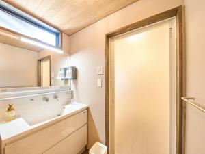 a bathroom with a sink and a mirror at 縁や出雲 in Taisha +32 photos