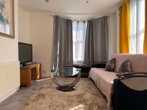 a living room with a couch and a glass table at Gillingham Hidden Gem in Gillingham