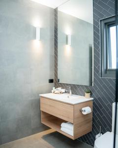 a bathroom with a sink and a mirror at 13th Beach Golf Lodges in Barwon Heads +19 photos