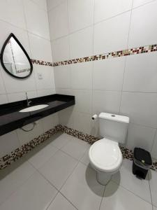 a bathroom with a white toilet and a sink at Quarto privado próximo ao centro 3 in Manaus
