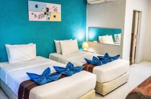 two beds in a room with blue flowers on them at Six Pack Cottage in Chalong +37 photos